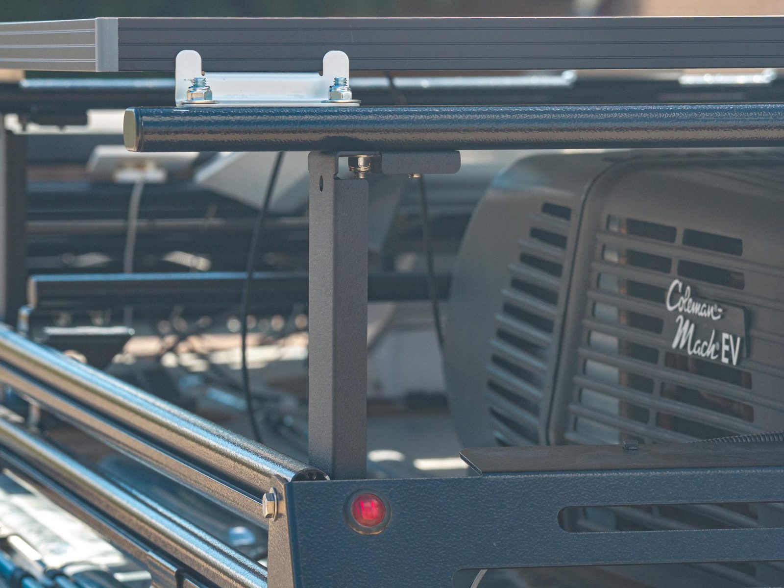Side view of a Mesa Riser on the rack with the A/C unit behind it and the solar panel mounted above